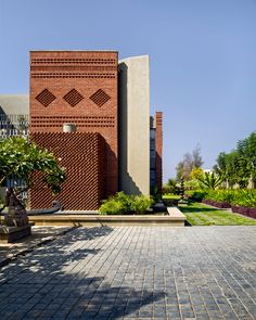 a large brick building sitting on top of a lush green field