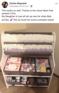 an image of a baby changing table with lots of diapers on the bottom shelf