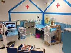 a child's hospital room with blue walls and furniture