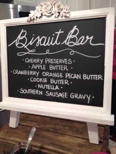 a sign that says biscuit bar on top of a wooden table in a kitchen