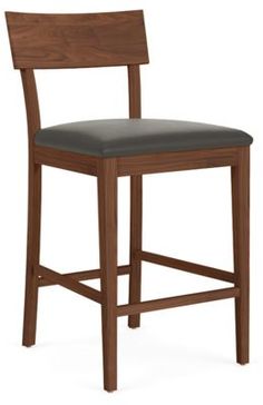 a wooden bar stool with black leather seat