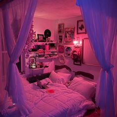 a bedroom with pink lighting and purple curtains