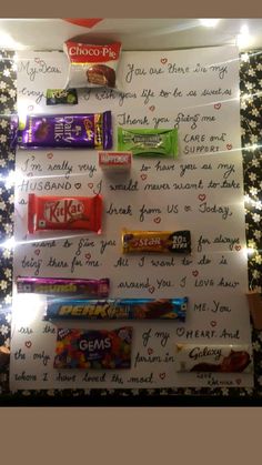 a christmas tree made out of candy bar wrappers and lettered to someone on the wall