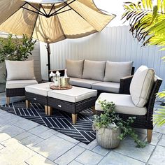 an outdoor living area with patio furniture and umbrella