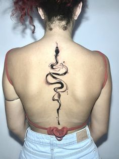 a woman with a snake tattoo on her back