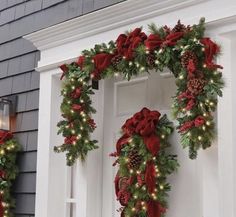 two christmas wreaths are hanging on the front door