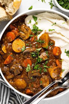 a bowl filled with stew and mashed potatoes