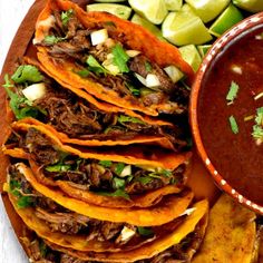 a plate full of tacos, tortillas and salsa