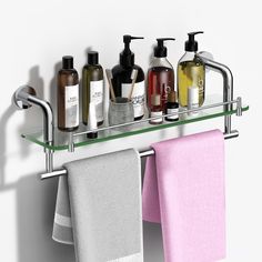 a bathroom shelf with soaps, lotions and hand towels hanging on the wall