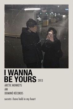 two people standing next to each other in front of a sign that says i wanna be yours arctic monkeys