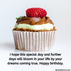 a cupcake with chocolate frosting and raspberries on top that says, i hope this special day and further days will bloom in your life by your dreams coming true happy birthday