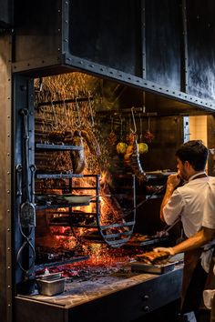 a man cooking food on top of a grill