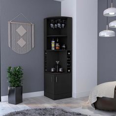 a black corner cabinet with drinks on it in a room next to a bed and rug