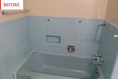 a bathroom with blue tiles and a bathtub that has no shower curtain on it