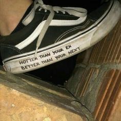 someone wearing black and white shoes with writing on the side of their shoelaces that says, rotten than your ex better than your next