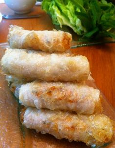 four fried food items stacked on top of each other next to lettuce leaves