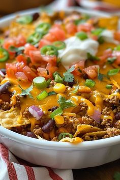 a casserole dish filled with beans, cheese and other toppings