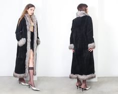 y2k black suede maxi coat with grey faux fur trim> two front pockets> four hooks and eye closure> deep interior pocket> quilted lining label> front line material> genuine leather | acrylic faux fur trim size> D 38 | NL 38 | F 40 |GB 12 | I 44 | USA 8 | E 40 | DK 38 shoulder to shoulder> 44cm sleeve> 60cm bust> 110cm waist> 103cm length> 144cm condition> great vintage condition> gently used  | model is 173 cm [5'8"] and measures 82-60-88cm [32"-23"-35"] | Full Length Winter Outerwear With Pockets, Black Full-length Winter Outerwear, Fitted Long Fur Coat With Faux Fur Lining, Long Fitted Fur Coat With Faux Fur Lining, Long Fur Coat, Maxi Coat, E 40, Y2k Black, Fur Trim