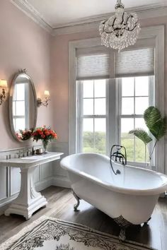 a white bath tub sitting next to a sink in a bathroom under a chandelier