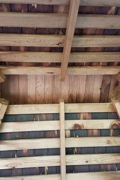 the inside of a wooden structure with wood slats