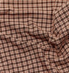 a brown and white checkered shirting fabric with a small amount of wrinkles