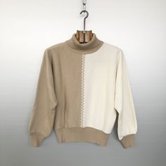 Beautiful vintage beige and ivory sweater. Very cool two-tone knitting with a diamond pattern between the 2 colours. Turtleneck and bat sleeves, so 80s! Very soft and swooth virgin wool fabric. MATERIALS & CONDITION Material is 60% acrylic / 40% virgin wool Condition is : very good vintage condition MEASUREMENTS Size is D 44 (refer to measurements) Do not hesitate to DM if you have any questions ! Armpit to armpit : 53cm / 20,75in Sleeve (collar seam to bottom) : 63cm / 24,75in Front length (col 80s Turtleneck, Beige Leather Jacket, Black Suede Jacket, Bat Sleeves, Sleeves Sweater, Vintage Pullover, Pullover Outfit, Ivory Sweater, Bat Sleeve