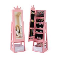 a pink doll's dressing table and mirror with jewelry on it