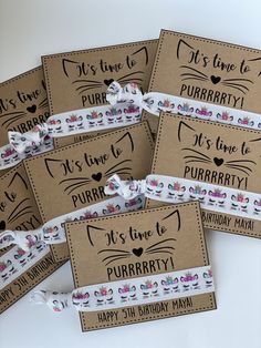 six personalized birthday party favors in brown paper with white ribbon and pink flowers on them