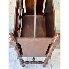 an old wooden chair with two turned back legs