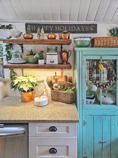 a kitchen filled with lots of green plants and pots on top of wooden shelving