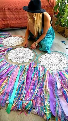 a woman sitting on the floor next to a large doily