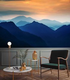 a living room with mountains painted on the wall and two chairs next to a coffee table