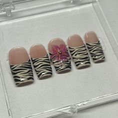 This set of tropical, spring time nails includes a beige french tip with a zebra stripe design on all fingers. For an extra touch of spring, a handmade 3D flower adorns the middle fingers and adds a pop of pink.  Available in shape Medium Square. This set includes 10 nails fit to your personal sizes in the exact design pictured. Follow instructions listed in personalization for accurate sizes as refunds for incorrect sizes are not permitted.  Included in this purchase is: - Acrylic Display Case - 10 Nails in desired design - Application kit - Stickers and Thank Yous Beige French Tip, Duck Nails Zebra Print, Zebra French Tip Nails, Pink Zebra French Tip Nails, Pink Zebra Print French Tip Nails, Spring Time Nails, Zebra Print Hello Kitty Nails, Time Nails, 2000s Zebra Nails