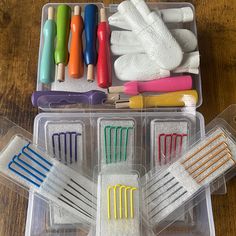 there are many different colored toothbrushes in the box on the table and one is empty