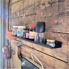 there is a shelf with spices and jars on it