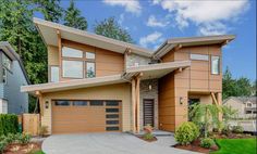 a large house with two garages in the front and one on the other side