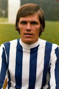 an old photo of a man in striped shirt