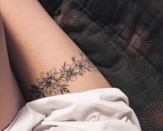 a close up of a person's leg with flowers on it