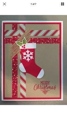 a christmas card with a stocking hanging from the side and a ribbon on top