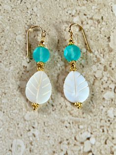 Mother of Pearl Earrings featuring a 20MM carved mother of pearl teardrop stone accented with an 8MM faceted aqua chalcedony stone ,Swarovski crystals and gold plated spacers. Earrings measure 1 1/2 inches and are handmade.  Ear wires are gold filled. GIFT BOXED Handmade Mother Of Pearl Teardrop Earrings, Teardrop Mother Of Pearl Earrings With Ear Wire, Chalcedony Stone, Mother Of Pearl Earrings, Aqua Chalcedony, Handcrafted Artisan Jewelry, Shell Jewelry, Pearl Drop Earrings, Pearl Drop