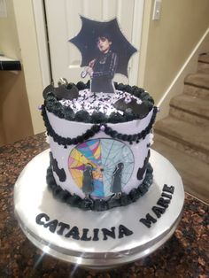 a cake decorated with an umbrella and the name catalina ruth on it's side