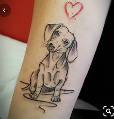 a dog with a heart tattoo on its arm