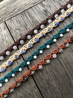 multicolored crocheted lace on wooden planks with beads in the center