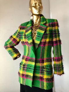 MARY ANN RESTIRO stunning  wool and mohair blazer tailored single breasted jacket for special occasions  semi-fitted green pink and yellow windowpane plaid blazer  all the plaids are skillfully matched low v front with one button closure exquisite wool and mohair fabric brilliant bold color and plaid combination strong shoulders with  shoulder pads notched lapels  set in long sleeves with tailored cuffs  one welt breast pocket and two hip front welt pockets set in long sleeves with tailored cuffs  below hip length jacket fully lined designer jacket good condition- the workmanship is splendid  1980s sustainable vintage  made in in the USA SZ 10  bust 36" waist 32" hips 38" jacket length 30" sleeve length 23" shoulder width16.5" Fitted Green Blazer For Fall, Green Fitted Blazer For Fall, Green Fitted Tweed Jacket With Notch Lapel, Fitted Green Tweed Jacket With Notch Lapel, Green Single-breasted Tweed Jacket For Formal Occasions, Green Single Breasted Tweed Jacket For Formal Occasions, Fitted Green Single-breasted Tweed Jacket, Fitted Green Tweed Jacket For Winter, Formal Green Single-breasted Tweed Jacket