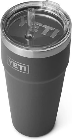 the yeti cup is purple and has a straw in it