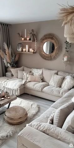 a living room filled with white furniture and lots of pillows on top of it's floor