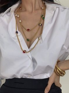 This vintage-inspired multi-layered necklace adds a touch of elegance and sophistication to any outfit. The combination of bold red, green, and blue gemstones, along with delicate pearls, creates a stunning contrast that enhances both formal and casual attire. With a versatile design, this necklace can also double as a statement waist chain, adding a unique flair to your style. The 1.8-meter length allows for various wearing options, making it a must-have for any jewelry collection. Details Material: Synthetic pearls, copper alloy with gold plating, colorful gemstones Color: Gold with red, green, and blue accents Style: Vintage-inspired multi-layered necklace Length: 1.8 meters (adjustable) Elegant Multicolor Necklaces For Formal Occasions, Elegant Multicolor Jeweled Necklaces, Elegant Red Chain Necklace For Party, Elegant Red Pearl Necklace, Red Pearl Chain Necklace For Party, Elegant Red Jeweled Necklace, Elegant Multicolor Jewelry With Chain, Elegant Multicolor Pearl Chain Necklace, Multicolor Pearl Necklace For Parties