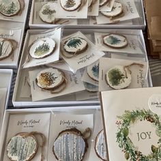 there are many christmas cookies in the boxes on display with cards and other items to make them look like they have been decorated