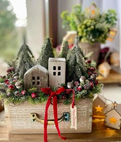 a wooden box filled with christmas decorations on top of a table