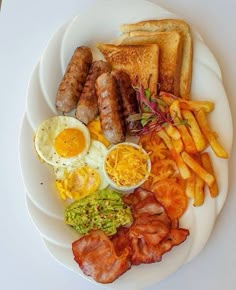 a white plate topped with different types of breakfast foods